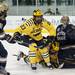 Michigan senior center A.J. Treais and sophomore left wingman Alex Guptill collide into the goalie the game against Notre Dame on Friday. Daniel Brenner I AnnArbor.com